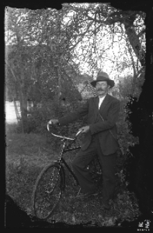 Man with rifle and bicycle