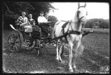 A group of people on a horse-drawn carriage