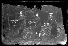 Woman and two men on bicycles