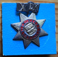 Oznaka "Dziesięciolecia Domu Książki"