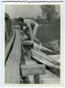 Mężczyzna wspinający się na drewniany most