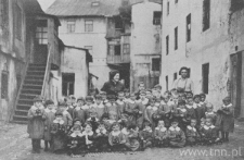 Yard of the tenement house on 41 Krawiecka Street - children from the “Ognisko” kindergarten with their teachers: Anna Szwarc and Bela Dobrzyńska.