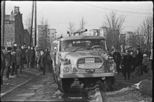 Ludzie zgromadzeni wok&oacute;ł wozu strażackiego