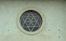 Okulus wypełniony witrażem z motywem gwiazdy Dawida znajdujący się nad wejściem głównym do synagogi w Orli
