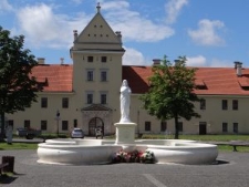 The Zhovkva Castle, in the 17th century a royal residence of Polish king Jan III Sobieski, a fountain with the statue of Virgin Mary in the foreground