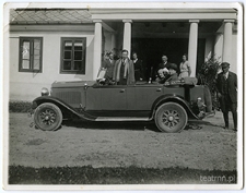 Auto z rodzinami Dąbrowskich i Zembrzuskich na tle ganku dworu w Moniakach